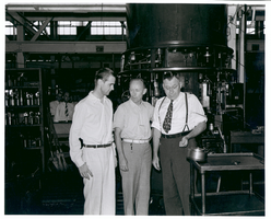 Photograph of Howard Hughes and others at Hughes Tool Company, Houston, Texas, July 30, 1938