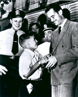 Photograph of Howard Hughes shaking hands with a young fan, Washington, D.C., circa 1947