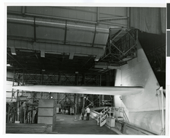 Photograph of the interior of an airplane hangar at the Hughes Helicopters Division of Summa Corporation, Culver City, California, circa late 1950s
