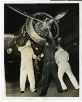 Photograph of men and the Lockheed 14, circa late 1930s