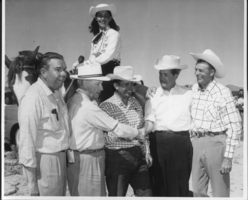 Bill Elwell, Frank Garside, Chas. Cavanaugh, Alan Bible, Rex Bell, with unidentified woman on horseback in Tonopah, Nevada: photographic print