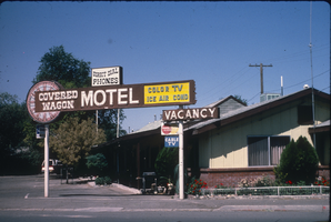 Slide of the Covered Wagon Motel and its neon signs, Lovelock, Nevada, 1986