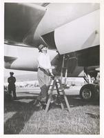 Photograph of Howard Hughes climbing into the XF-11, Culver City, California, July 7, 1946