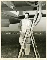 Photograph of Howard Hughes underneath the XF-11 plane, April 3, 1947