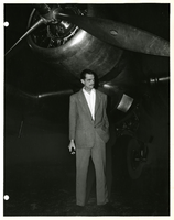 Photograph of Howard Hughes standing near Douglas DC-3, New York, 1947
