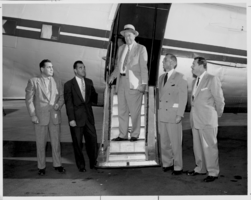 Photograph of L. A. Hyland arriving at the airport, Culver City, California, November 22, 1954