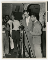 Photograph of Howard Hughes giving a news conference next to his DC-3, New York, 1947