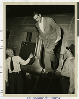 Photograph of Howard Hughes emerging from his Douglas DC-3, New York, April, 1947