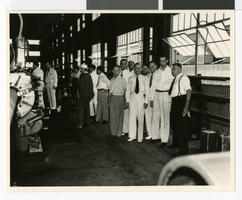 Photograph of Howard Hughes and men at Hughes Tool Company, Houston, Texas, July 30, 1938