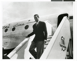 Photograph of Howard Hughes descending the stairway of the Constellation 069 plane, Washington D.C., April 17, 1944