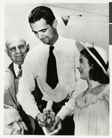 Photograph of Howard Hughes with Hughes Tool Company employees, July 30, 1938
