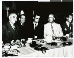 Photograph of Howard Hughes seated at banquet table, circa 1930s