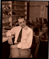 Photograph of Howard Hughes in a film editing lab, circa 1950