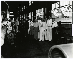 Photograph of Howard Hughes and employees at the Hughes Tool Company, Houston, Texas, July 30, 1938