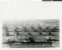 Photograph of pilots lined up in front of their biplanes at the Oakland Airport, California, March 15, 1929