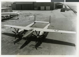 Photograph of the first XF-11, with a Constellation plane in the background, 1946