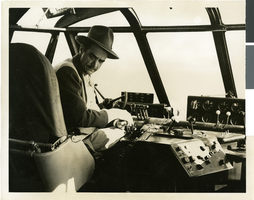 Photograph of Howard Hughes sitting in the cockpit of the Hughes Flying Boat, Los Angeles Harbor, November 1, 1947
