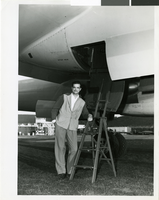Photograph of Howard Hughes standing by the XF-11 plane, April 3, 1947