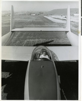Photograph of Howard Hughes sitting in the cockpit of the XF-11 preparing for his first test flight in Culver City, California July 7, 1947
