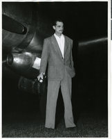 Photograph of Howard Hughes standing next to an airplane circa 1940s/1950s