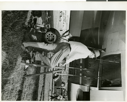 Photograph of Hughes entering his plane for inspection, approximately 1945-1955