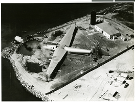 Aerial photograph of Hughes' seaplane docked at harbor, Los Angeles (Calif.), July 1947