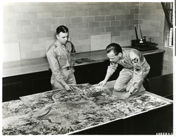 Photograph of aerial photographic map viewed by Lt Marvin R. Williams and Sgt. Erickson, circa 1940s-1950s.