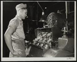 Photograph of a man working on rock bit drilling pieces at the Hughes Tool Co., Houston, Texas, circa 1950s