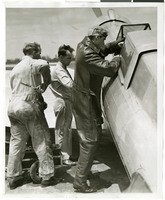 Photograph of Howard Hughes with aircraft technicians with the Northrop Gamma Racer, 1936