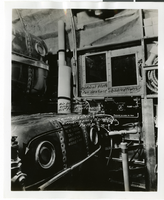 Photograph of outboards, tanks, and pumps inside plane, 1930-1950