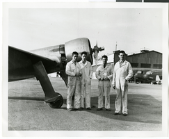 Photograph of four men next to aircraft propellers, 1930-1950