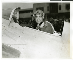 Photograph of Hughes in cockpit after record-breaking flight, Newark (N.J.), January 19, 1937