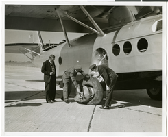 Photograph of attendants inspecting a plane, Brooklyn, New York, September 30, 1937