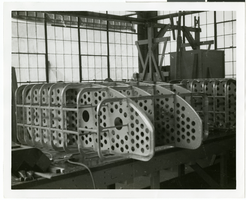 Photograph of an airplane part during assembly, circa 1920s-1950s