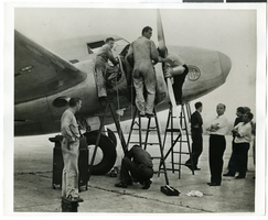 Photograph of mechanics with the Lockheed 14 aircraft, July 10, 1938