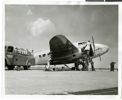 Photograph of mechanics with the Lockheed 14 aircraft, New York, July 10, 1938