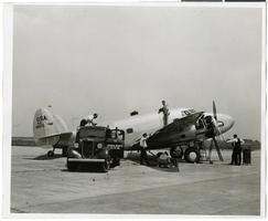 Photograph of mechanics with the Lockheed 14 aircraft, July 10, 1938