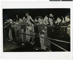 Photograph of a crowd greeting Howard Hughes at Floyd Bennett Field Airport, July 14, 1938