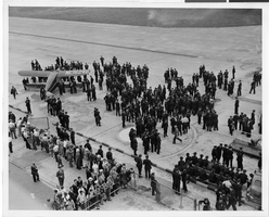 Photograph of a crowd awaiting the arrival of Howard Hughes' plane at Floyd Bennett Airport, New York, July 14, 1938