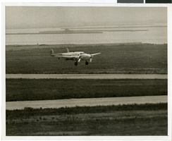 Photograph of the landing of Howard Hughes' Lockheed 14 aircraft, New York, July 14, 1938
