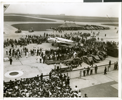 Photograph of the landing of Howard Hughes' Lockheed 14 aircraft, New York, July 14, 1938