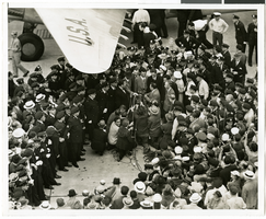 Photograph of Howard Hughes and crowds at Floyd Bennett Airfield, New York, July 14, 1938