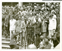 Photograph of Howard Hughes and crew posing for photographs outside of City Hall, New York City, July 15, 1938