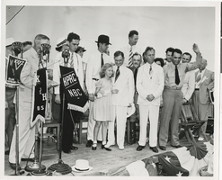 Photograph of Howard Hughes and others on stage, Chicago, 1938