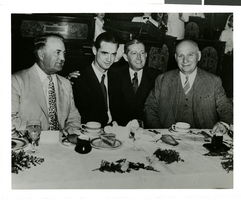 Photograph of Howard Hughes and other men at a banquet in Los Angeles, August 1, 1938