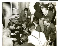 Photograph of Howard Hughes surrounded by newspapermen, Los Angeles, August 1, 1938