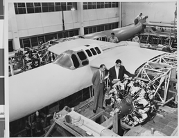Photograph of airplanes being built by Howard Hughes and workers, circa 1943