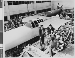 Photograph of airplanes being built by Howard Hughes and workers, circa 1943