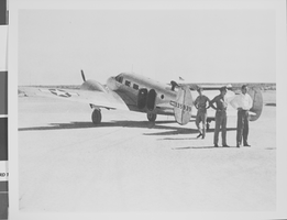 Photograph of Howard Hughes flying a plane, circa 1944