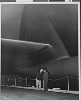 Photograph of Howard Hughes talking to an unidentified man, circa 1947